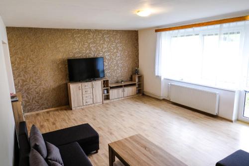 a living room with a flat screen tv on a wall at Vila Alice in Luhačovice