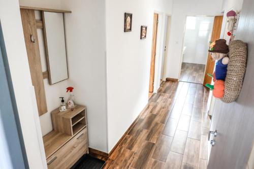 a room with a hallway with wooden floors and a door at Vila Alice in Luhačovice