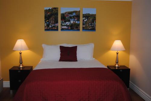 a bedroom with a large bed with two lamps at Arnold's Cove Inn in Arnold's Cove