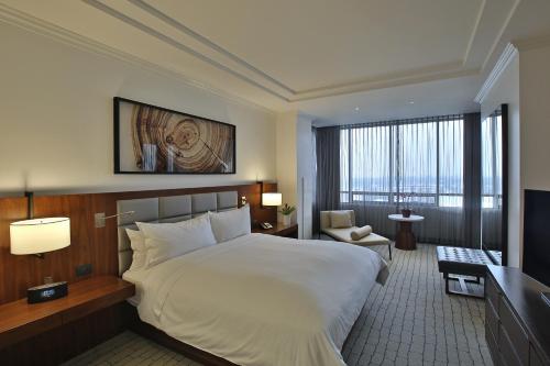a bedroom with a large bed and a large window at Intercontinental Real Guatemala by IHG in Guatemala