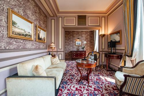 a living room with a couch and a table at InterContinental Bordeaux Le Grand Hotel by IHG in Bordeaux