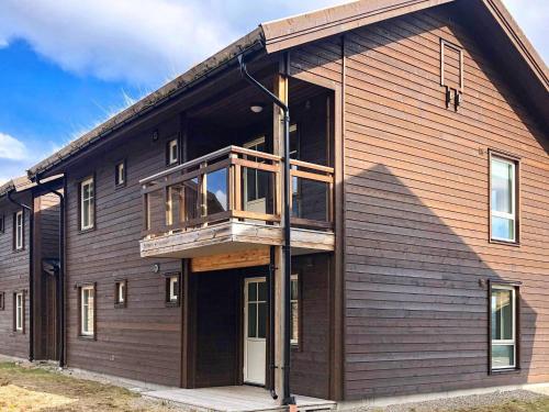 a house with a balcony on the side of it at 8 person holiday home in S LEN in Sälen
