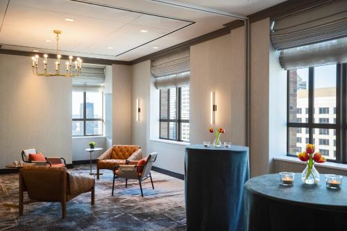 a lobby with a table and chairs and windows at Kimpton Hotel Palomar Philadelphia, an IHG Hotel in Philadelphia