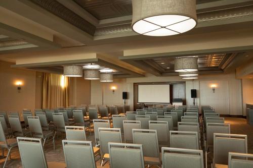 a room with rows of chairs and a projection screen at Hotel Indigo Traverse City by IHG in Traverse City
