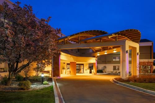 an exterior view of a hospital building at night at Holiday Inn Express Milwaukee - West Medical Center by IHG in Wauwatosa