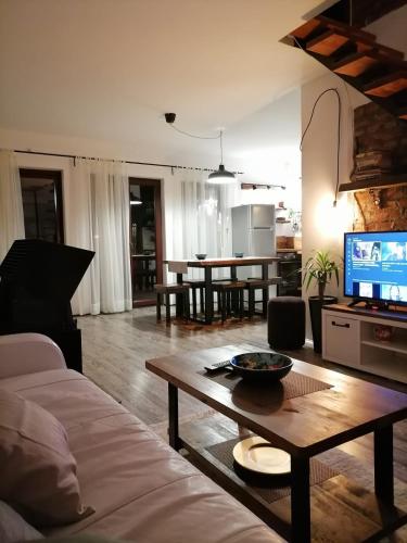 a living room with a couch and a table at Holiday Home Drinsko svitanje in Gornja Trešnjica