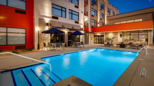 een zwembad voor een gebouw bij Best Western Plus Executive Residency Rigby's Water World Hotel in Warner Robins