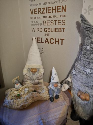 a bedroom with a bed with a sign on the wall at Haus Neuville in Medendorf, ruhige Lage in Bullange