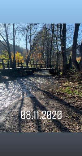 a picture of a road with trees and a bridge at Haus Neuville in Medendorf, ruhige Lage in Bullange