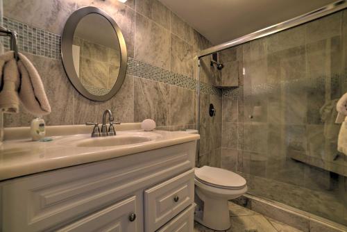 a bathroom with a sink and a toilet and a mirror at Beachfront Kihei Sanctuary with Lanai and Ocean Views! in Kihei