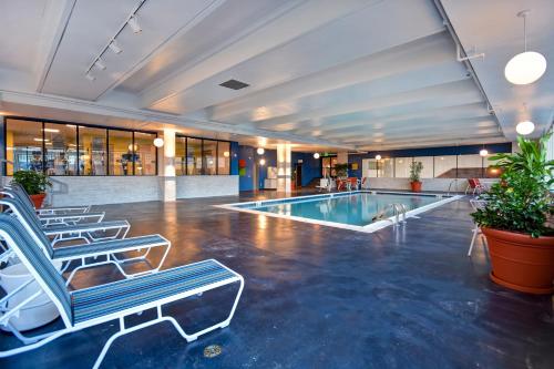 a pool in a hotel lobby with lounge chairs at Holiday Inn Lancaster by IHG in Lancaster