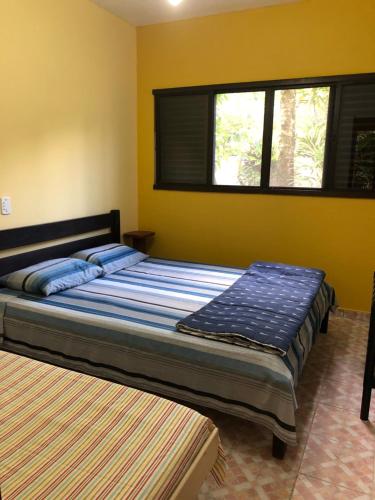 Tempat tidur dalam kamar di Apartamentos Araraquara