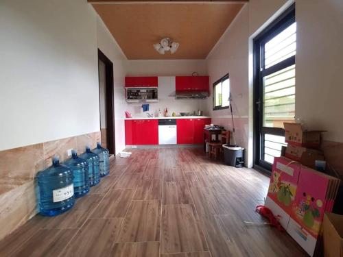 an empty room with red cabinets and bottles of water at Yanyu Xihu Villa in Xihu