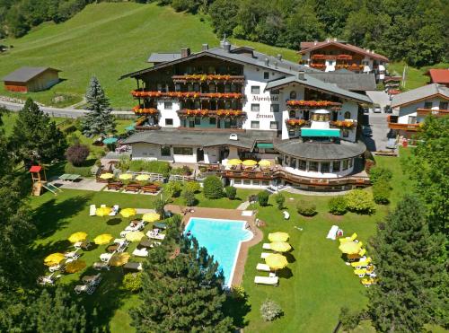 an aerial view of a resort with a swimming pool at Alpenhotel Fernau in Neustift im Stubaital