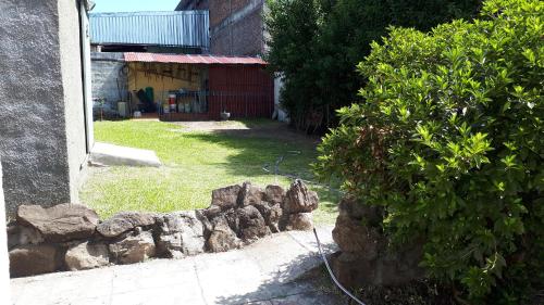 a garden with a pile of rocks next to a building at Apartamento Salto Uruguay in Salto