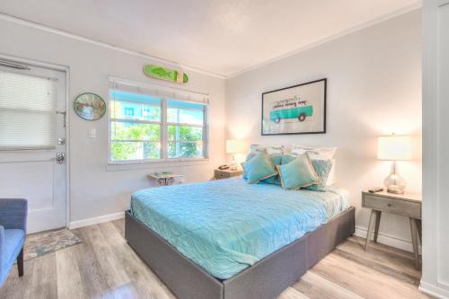 a bedroom with a bed and a window at Tropic Terrace #15 - Beachfront Rental condo in St. Pete Beach