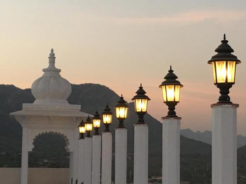 a row of street lights in front of a building at Regenta Central Mewargarh, Near Biological park in Udaipur