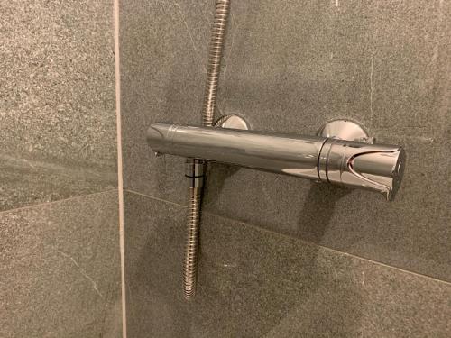 een metalen handdoekenrek in een douche met een slang bij Saint Johns Rest in Biggleswade