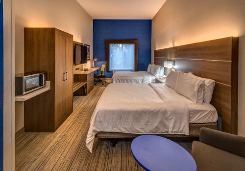 a hotel room with two beds and a tv at Holiday Inn Express Hotel & Suites Minden by IHG in Minden