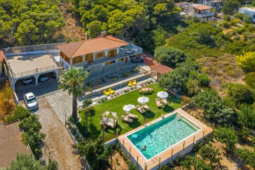 an aerial view of a house with a swimming pool at Villa Artemida Vravrona in Vravrona
