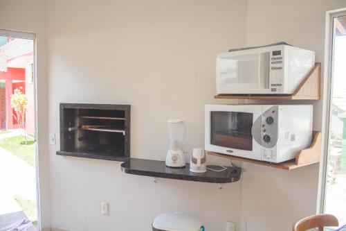 a kitchen with two microwaves and a microwave at Pousada Estrelas no Mar Florianópolis in Florianópolis