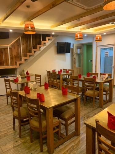 a dining room with tables and chairs with red bows at D's Casa - A Unique Spanish Boutique House in McLeod Ganj