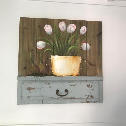 a painting of pink flowers in a pot on top of a drawer at XYL Holiday Inn in Caloundra