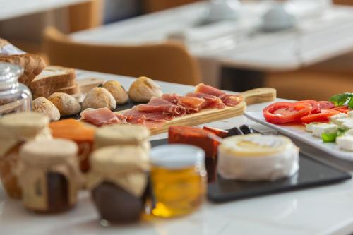 a table topped with plates of food on a table at Bacharéis Charming House in Figueira da Foz