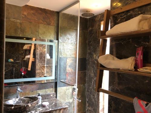 ein Bad mit einem Waschbecken und einem Spiegel in der Unterkunft Villa M45 Byoum- Fayoum in Qaryat at Ta‘mīr as Siyāḩīyah