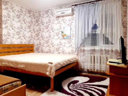 a bedroom with a bed and a window at Шевченко 2 in Kropyvnytskyi