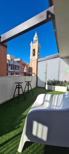 a balcony with a table and a clock tower at Terrazze Caracciolo in Pescara