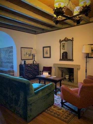 a living room with a couch and a fireplace at Parador de Vilalba in Villalba