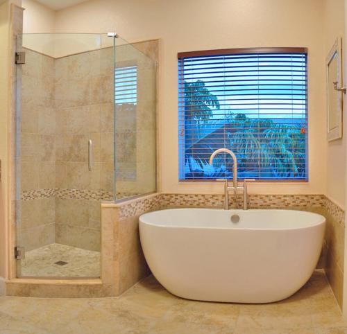 a bathroom with a tub and a glass shower at Avenida De Cortez 5210 in Siesta Key
