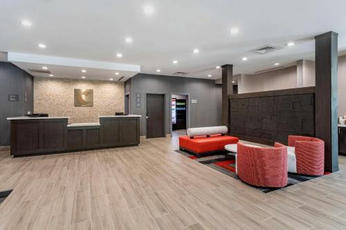 a lobby with a waiting area and red chairs at Comfort Inn & Suites in Olive Branch