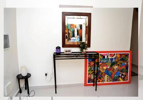 a mirror on a wall next to a table at Chez Ouly in Dakar