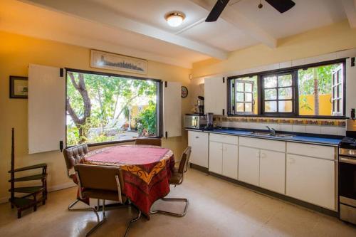 a kitchen with a table and a large window at Villa Seaside Boca Sami in Sint Michiel