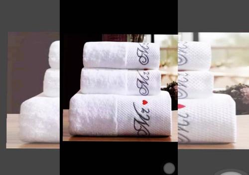 a stack of towels sitting on a table at Chez Ouly in Dakar