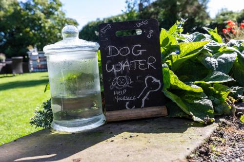 a glass jar filled with water next to a sign at Church Farm Guest House in Wellington