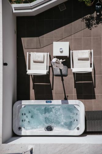 a bath tub with two chairs and a table at Villa Fiorella Art Hotel in Massa Lubrense