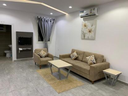 a living room with a couch and a table at Rawaat Ghaym in Taif