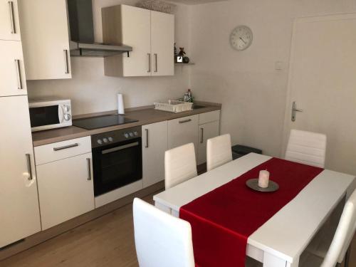 a kitchen with a table with a red table cloth at Katarina in Bled