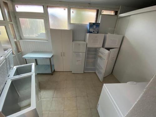 a small kitchen with white appliances and a table at Casa Daniel in Bran