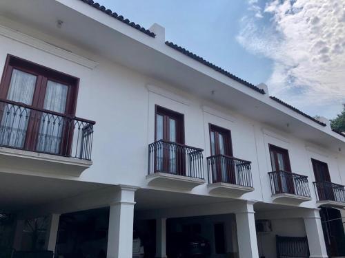 a white building with balconies on the side of it at Hotel San Joaquin SA de CV in Colima