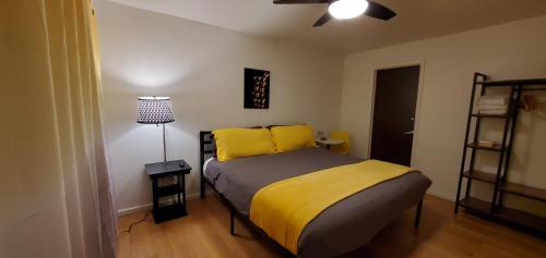 a bedroom with a bed with yellow pillows at The Mammoth Inn in Mammoth Lakes