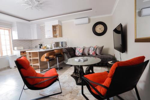 
a living room filled with furniture and a tv at Lefa Boutique Hotel in Rustenburg
