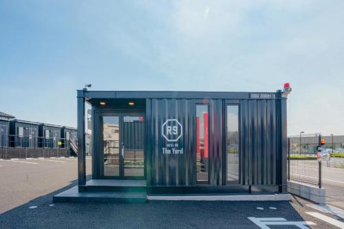 a bus stop in the middle of a parking lot at HOTEL R9 The Yard Isesaki in Isesaki