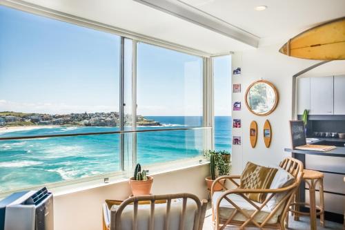a living room with a view of the ocean at Bondi Cloud Surf House by Sydney Dreams in Sydney