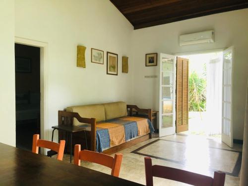 Sala de estar con cama y mesa en Casa Praia da Vila, en Ilhabela