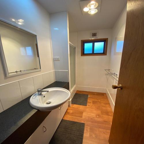 a bathroom with a sink and a mirror at Cobram Barooga Golf Resort in Barooga