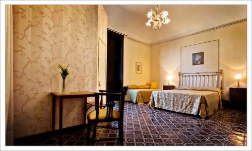 パチェーコにあるAgriturismo Antico Baglioのベッドルーム1室(ベッド1台、テーブル、椅子付)